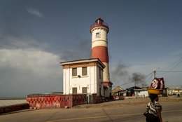 Lighthouse,-Street-vendor,-Head-load,-Informal-trade,-Daily-life,-British-colonial-architecture,-Victorian-era,-Coastal-road,-Mural,-Ga-district,-Jamestown,-Accra,-Ghana,-West-Africa